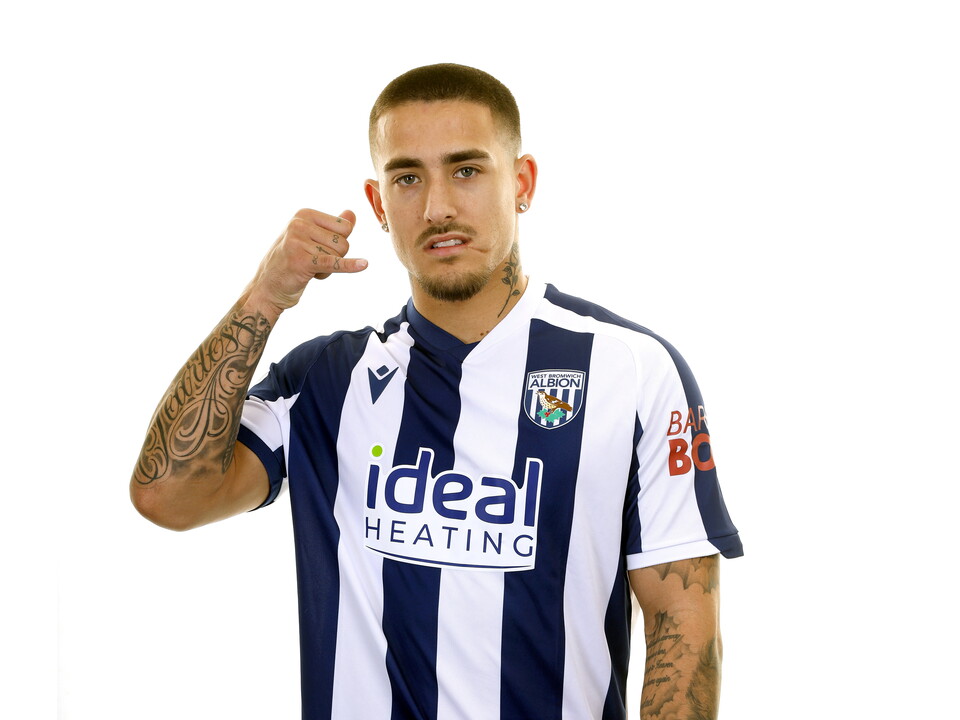 Danny Imray smiling at the camera while stood in front of a white background in a home WBA shirt