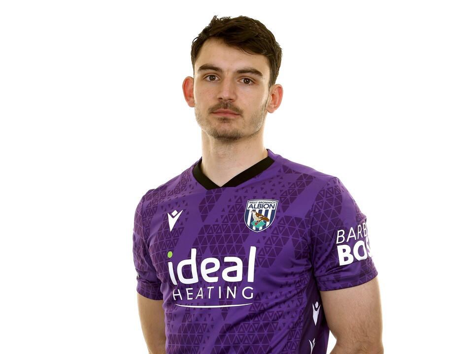 Max O'Leary looking at the camera while wearing a purple GK shirt 