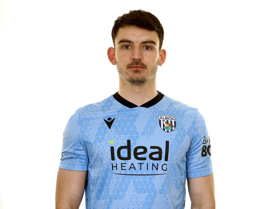 Max O'Leary looking at the camera while wearing a light blue GK shirt