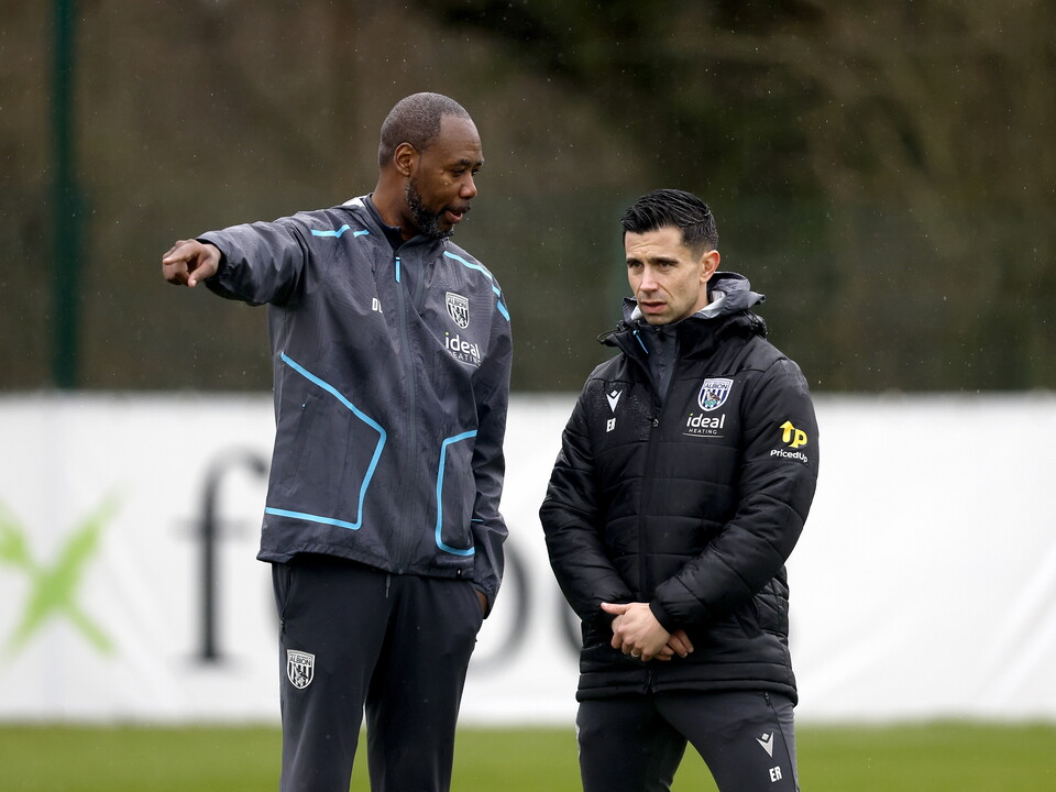 Eric Ramsay watching training in the rain stood next to Dennis Lawrence 