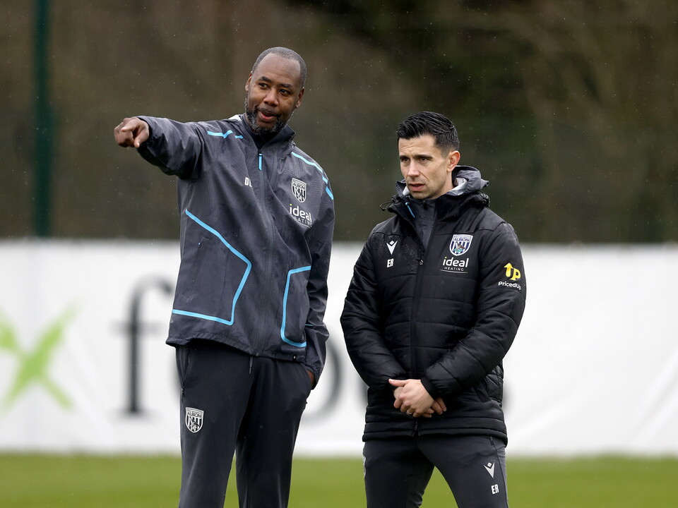 Eric Ramsay watching training in the rain stood next to Dennis Lawrence 