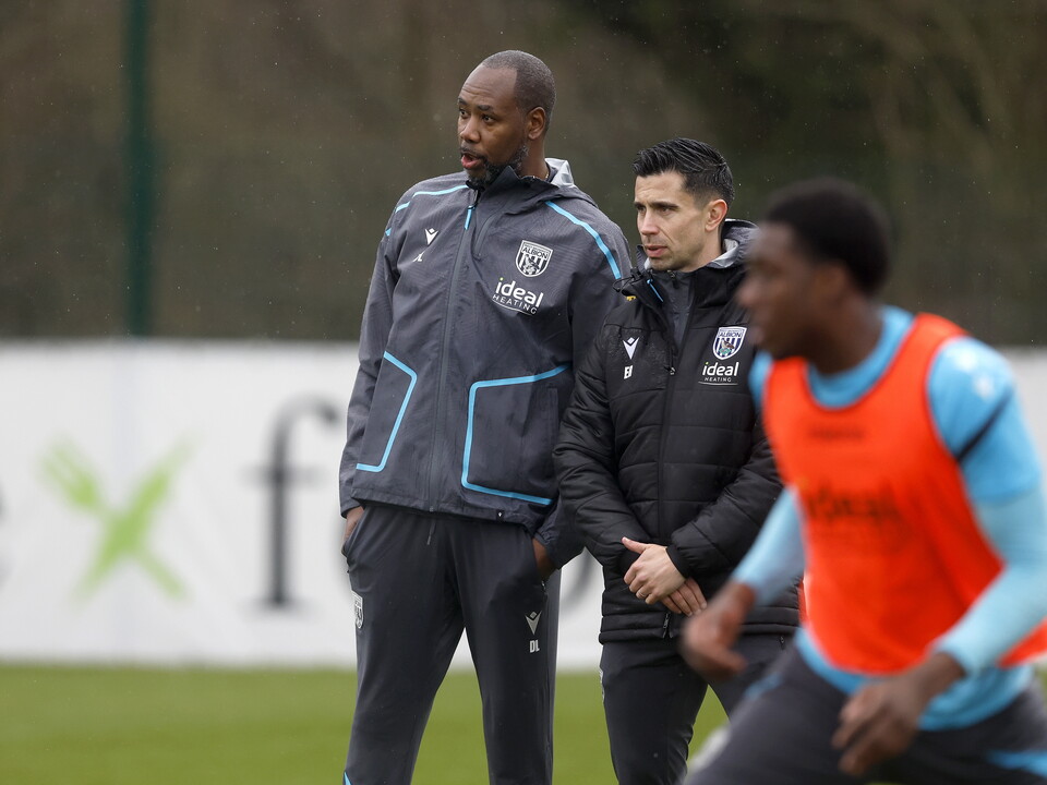 Eric Ramsay watching training in the rain stood next to Dennis Lawrence