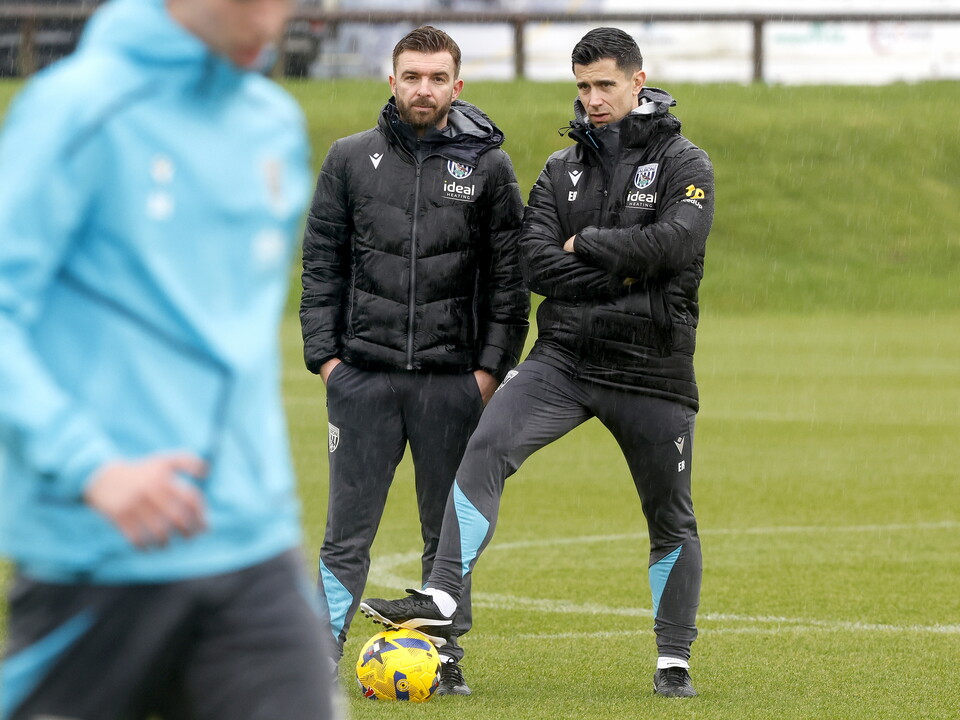 Eric Ramsay watching training in the rain while stood next to James Morrison