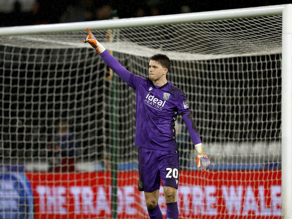 Josh Griffiths celebrates saving the penalty.