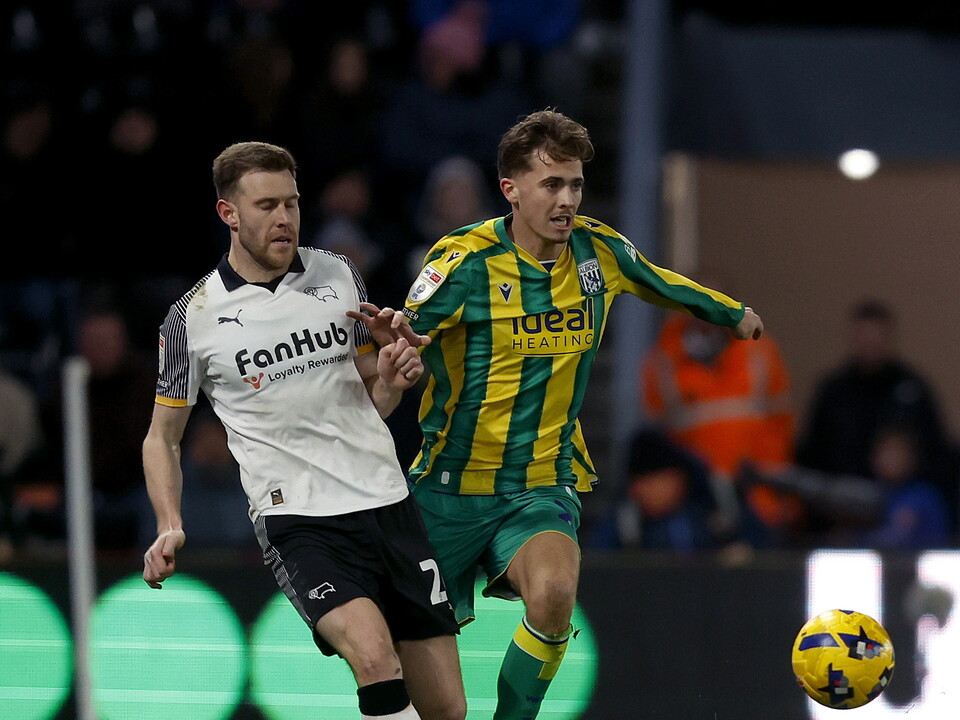 Isaac Price fighting for the ball with a Derby player