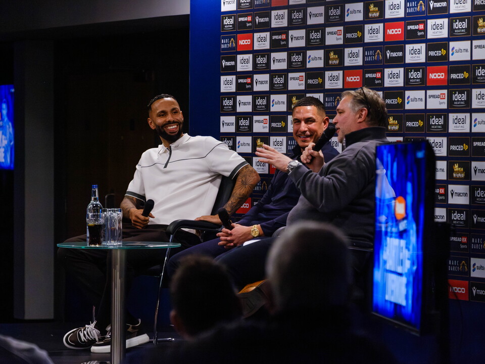 Andy Johnson speaking to Kyle Bartley and Jake Livermore as they're seated on stage