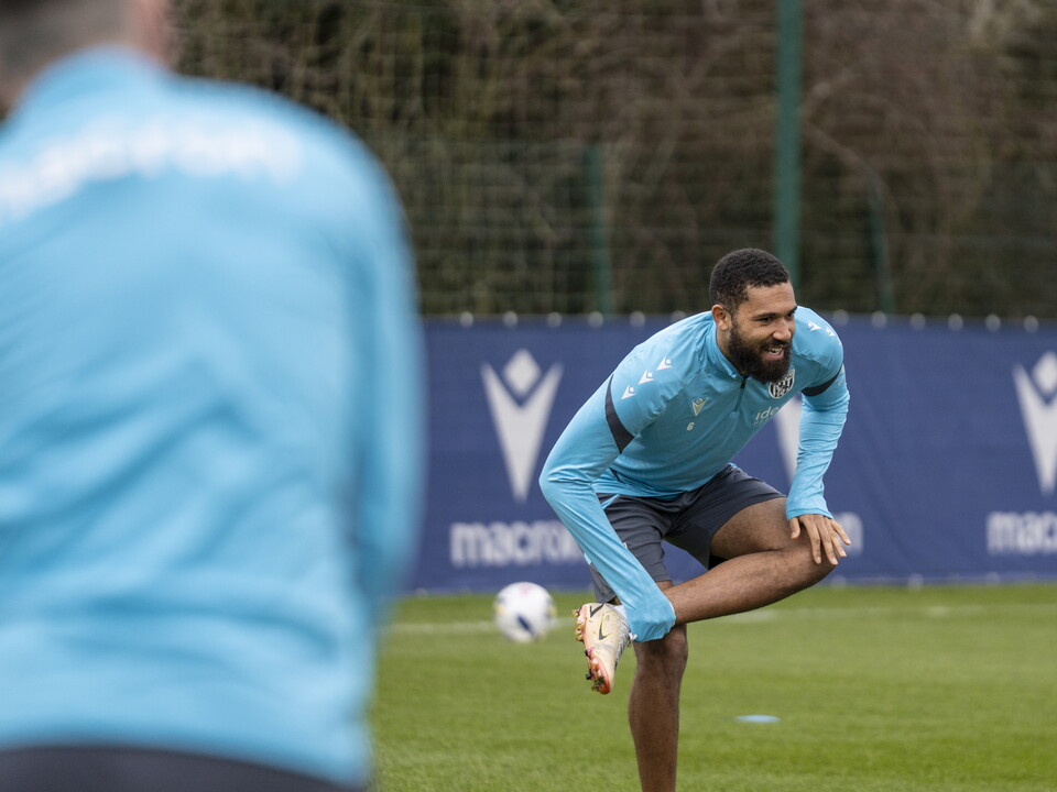 George Campbell stretching before a training session