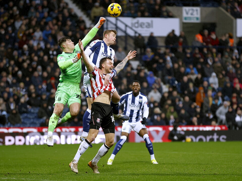 Several players jumping to try and win a ball in the air