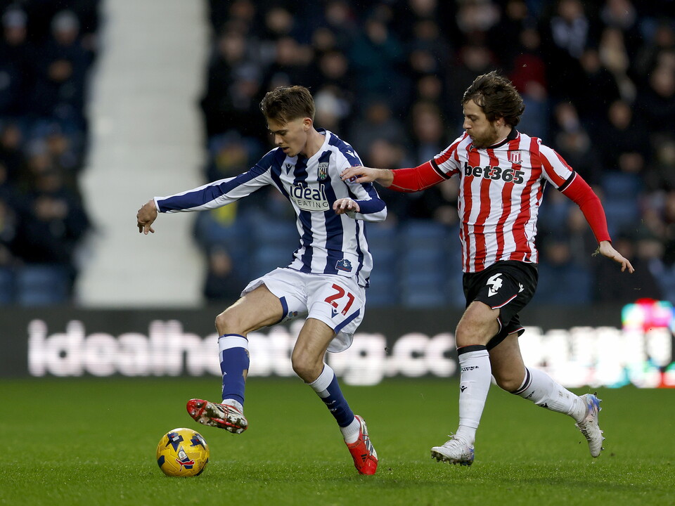 Isaac Price tussles with Ben Pearson for the ball.