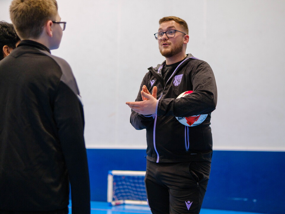 Limitless Apprentice coach in discussion with two participants.
