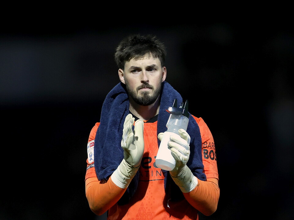 Joe Wildsmith with a towel around his neck and a water bottle in his hands