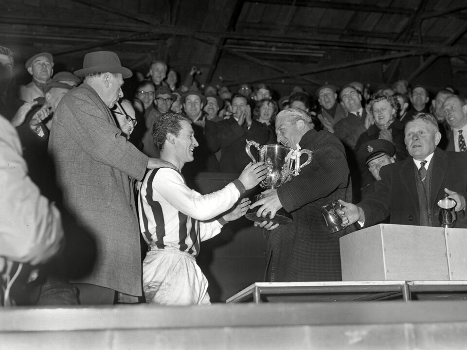 Graham Williams receives the League Cup trophy in 1966 at The Hawthorns in the stand