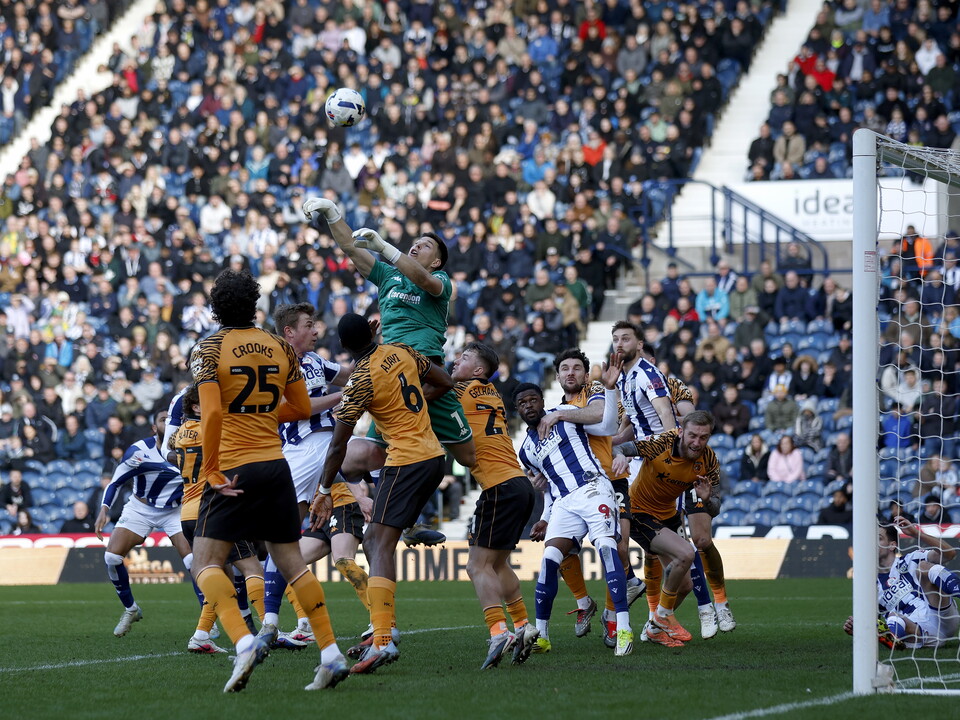 Several WBA & Hull players jumping to try and win an aerial ball in a penalty area