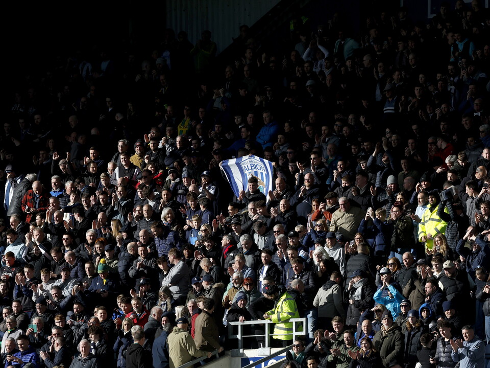 An image of Albion fans in a packed out away end