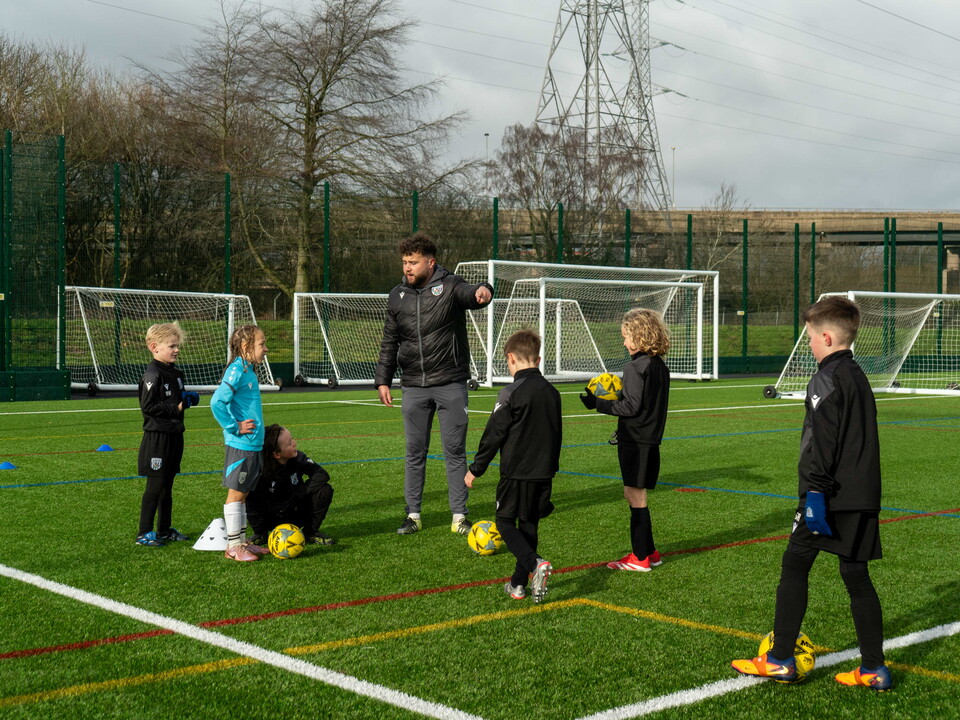 Coach giving instructions to participants