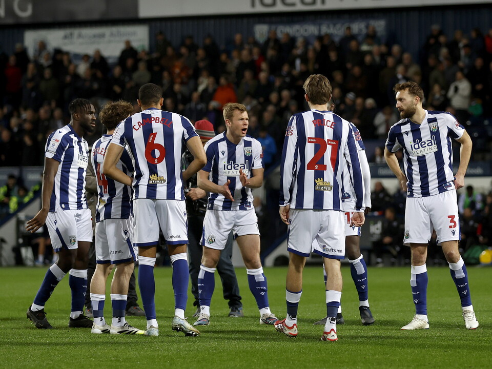 Several WBA players in a group on the pitch before the Millwall game 