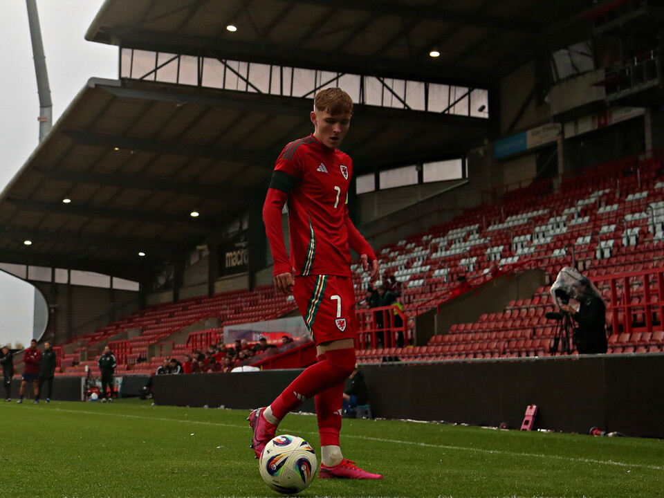 Ollie Bostock with the ball at his feet during a game for Wales