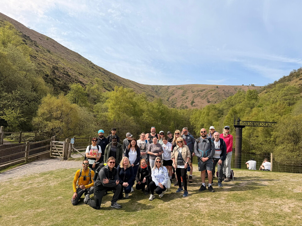 Participants gathered together with the hills in the background.