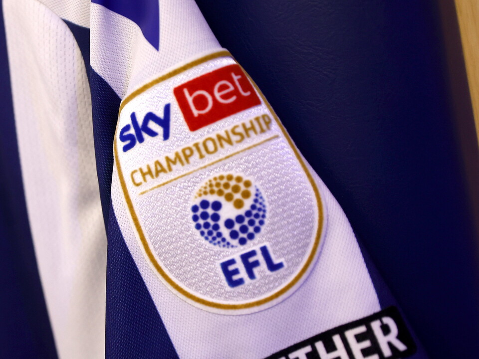A Sky Bet Championship badge on the sleeve of a home WBA shirt 