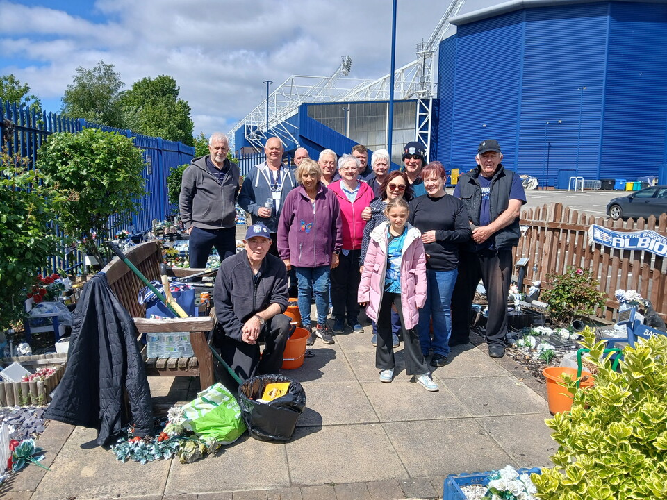 Volunteers posing for a photo in the WBA Memorial Garden 