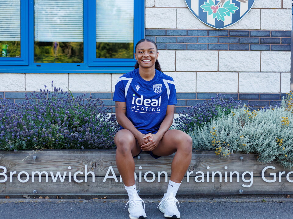 Izzy Lane sits outside the training ground