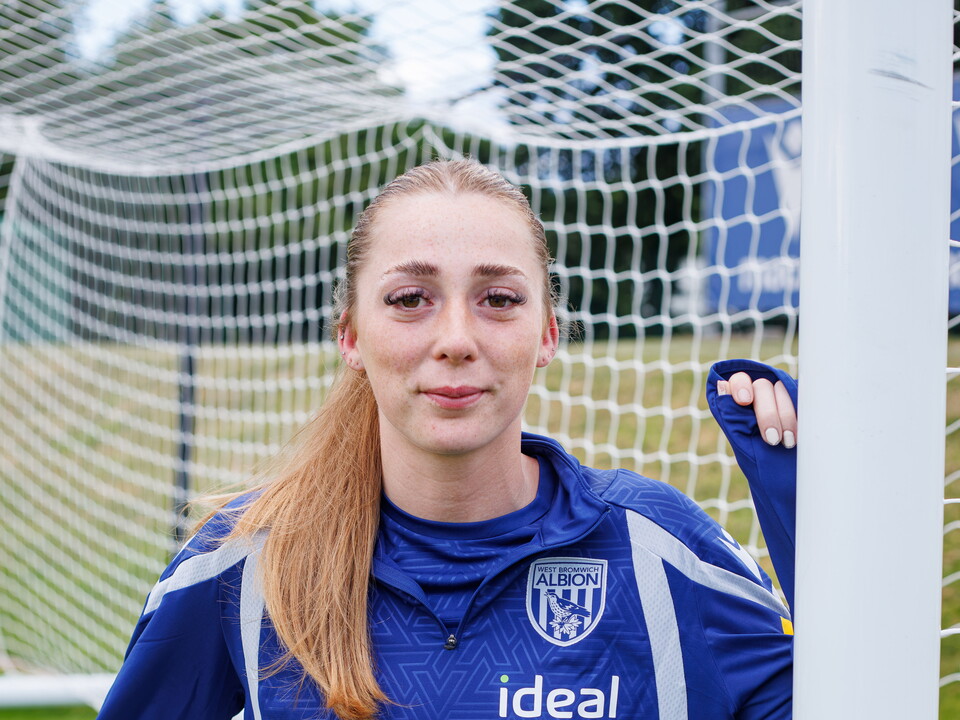 Harriet Grimshaw leans against a goalpost.