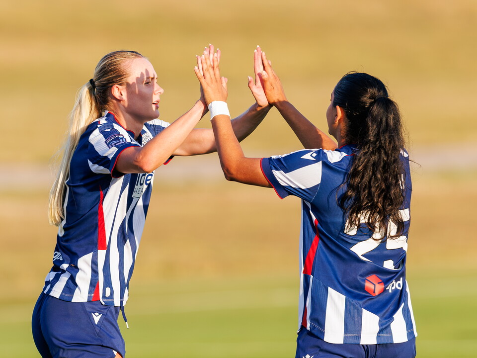Abbey Jones and Riya Mannu celebrating.