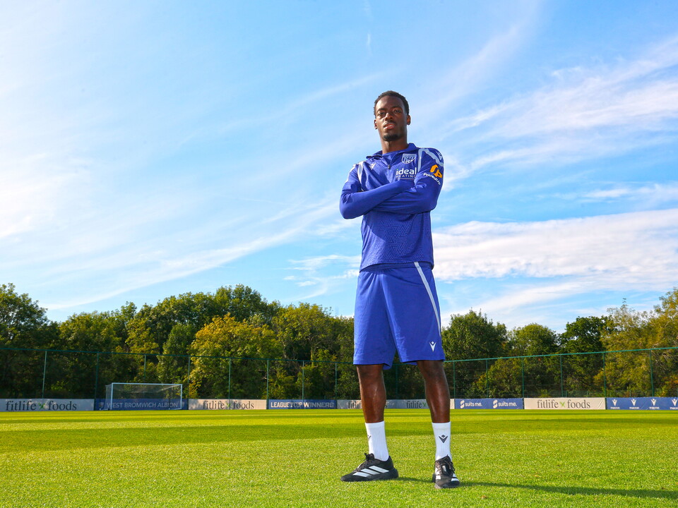 Rabby Nzingoula poses with his arms folded on the training pitch