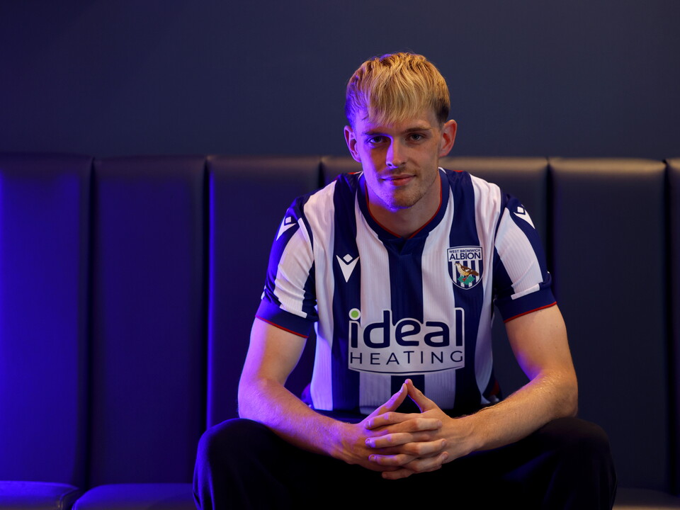 Toby Collyer poses in blue light