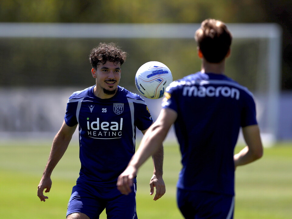 Nolan Galves smiling while watching the ball in mid-air during a training session