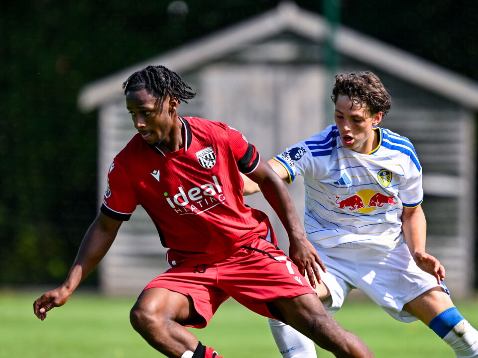 Remar McNeil battles with a Leeds United player.