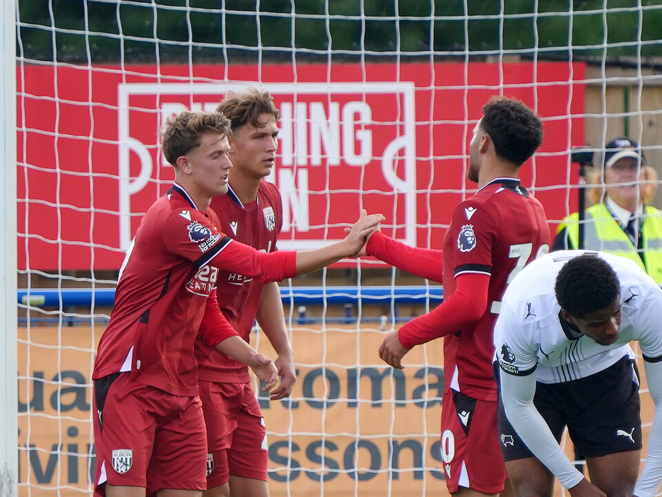 Jack Bray celebrates with Tammer Bany and Cole Deeming after scoring in the red away kit against Derby's PL2 team