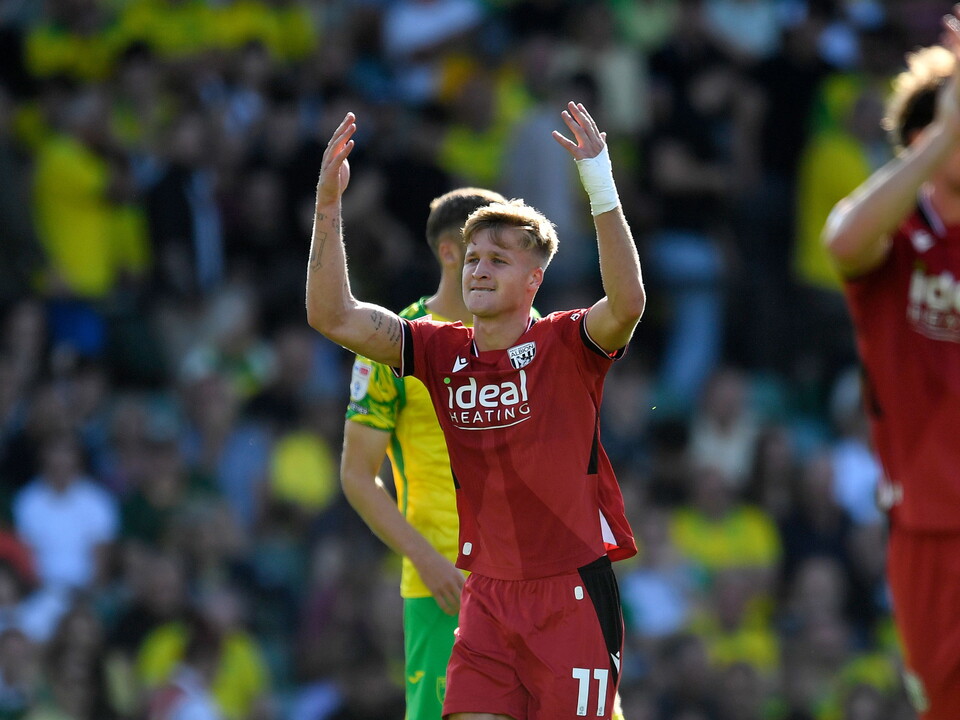 JJ Morgan celebrates scoring against Norwich City in the red away kit 