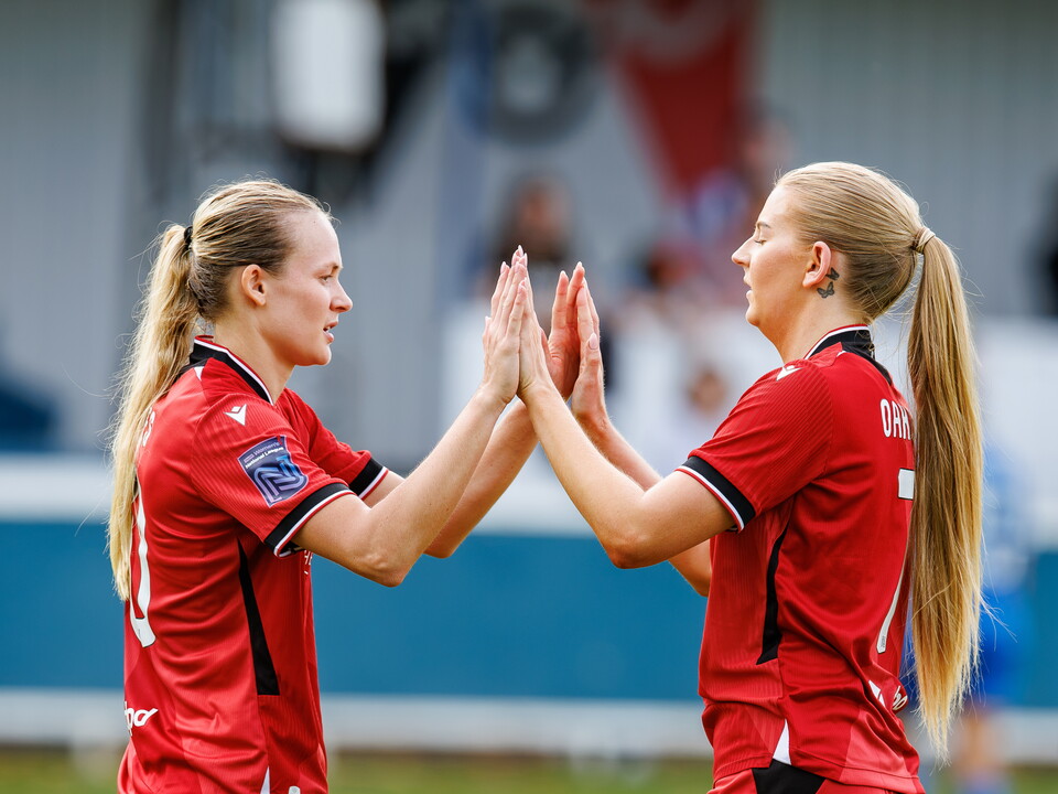 Albion Women high-fiving after scoring.