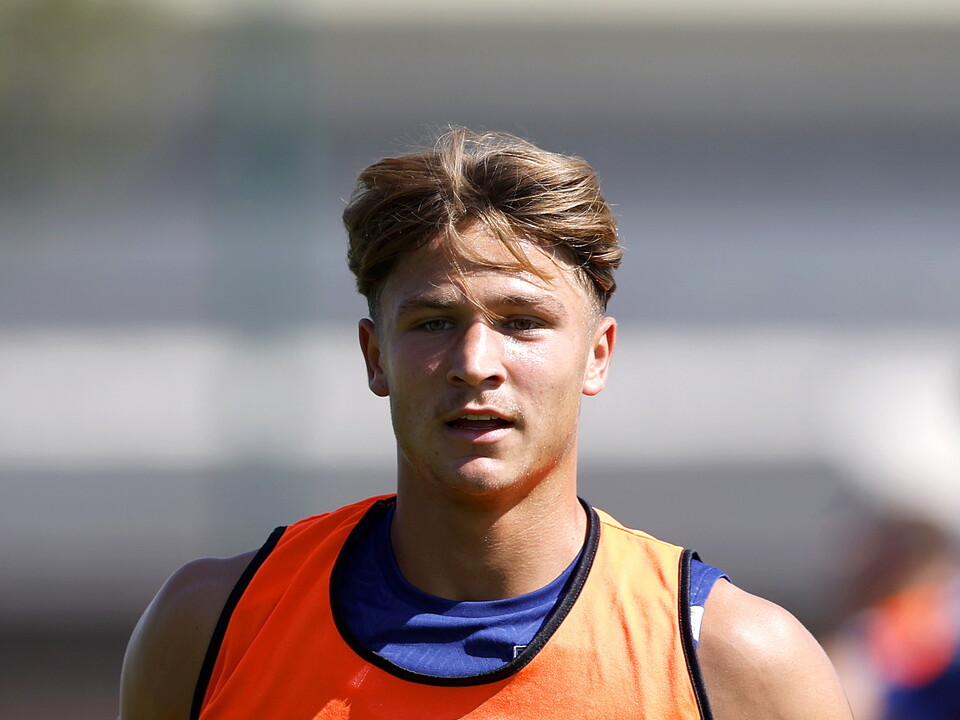A close-up shot of Cole Deeming in an orange bib