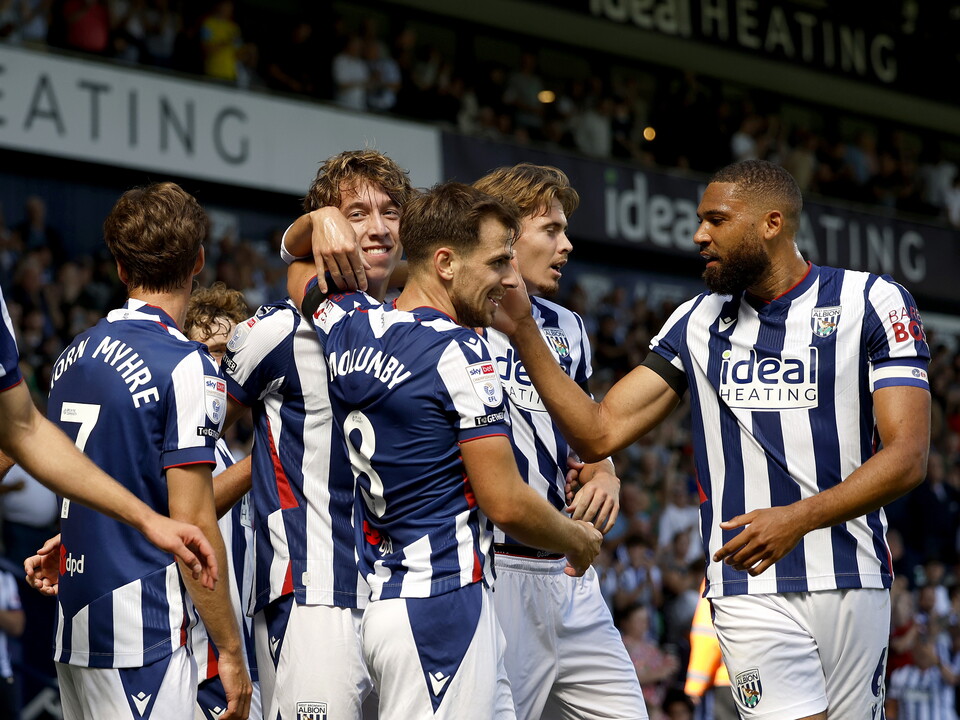 Several WBA players celebrate a goal scored in the home kit 