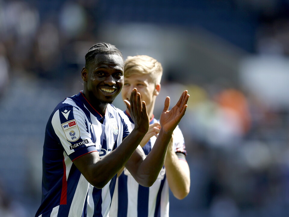 Ousmane Diakite smiles while applauding the home fans