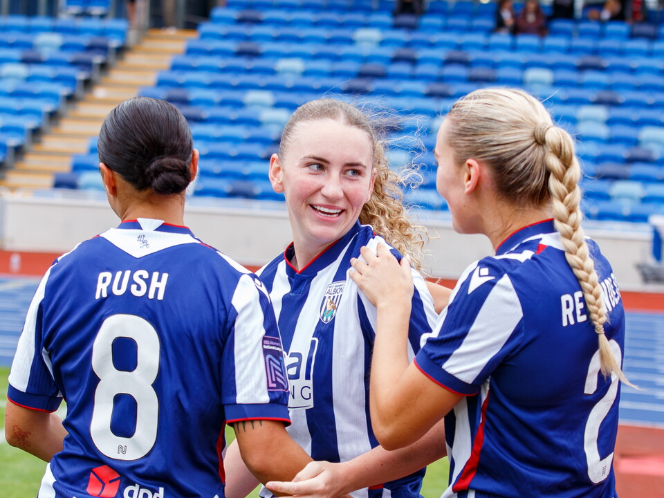 Monique Robinson celebrates scoring with team-mates Rhianne Rush and Taylor Reynolds 