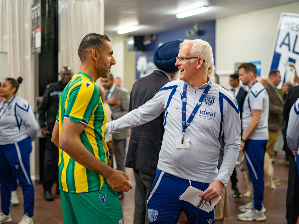Rob Lake and guest greeting each other