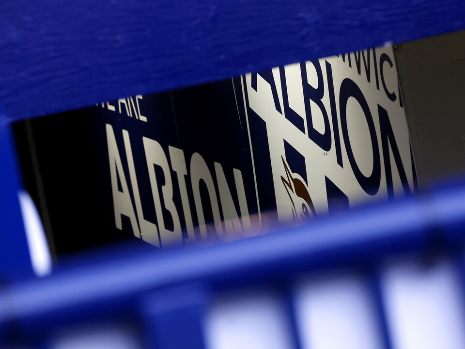 An image of Albion's badge on a wall