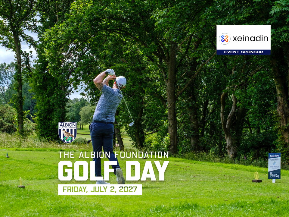 Golfer taking a swing with greenery in the background.