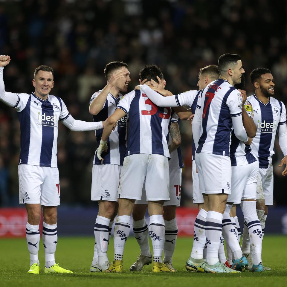 Several Baggies players in a huddle after a goal