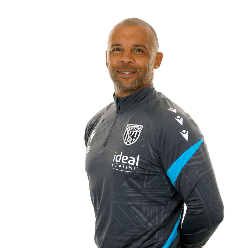 A photo of Albion Senior PDP Coach Deon Burton in the 2025/26 grey training kit